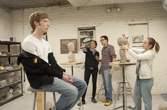 Plastic surgeons sculpt a bust with the help of sculptor Morgan Yacoe.